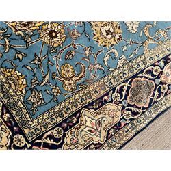 Persian Nain blue ground rug, overall arabesque design, the busy field decorated with interlacing branches and palmettes, indigo ground border with panels decorated with knots and lotus flower motifs, surrounded by trailing branches and flower heads, within guard stripes