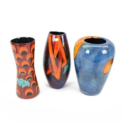 Three Poole pottery vases, one of baluster form in Wild Poppy pattern, two in red and green tones