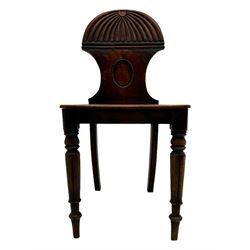 Regency mahogany hall chair, the carved back with shell motif and oval medallion, supported by turned front legs and splayed rear legs