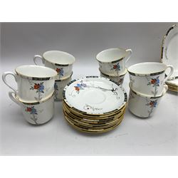 Art deco Shelley tea service for eight, decorated with floral sprigs, comprising teacup and saucers, dessert plates, two cake plates, milk jug and open sucrier, with to extra dessert plates