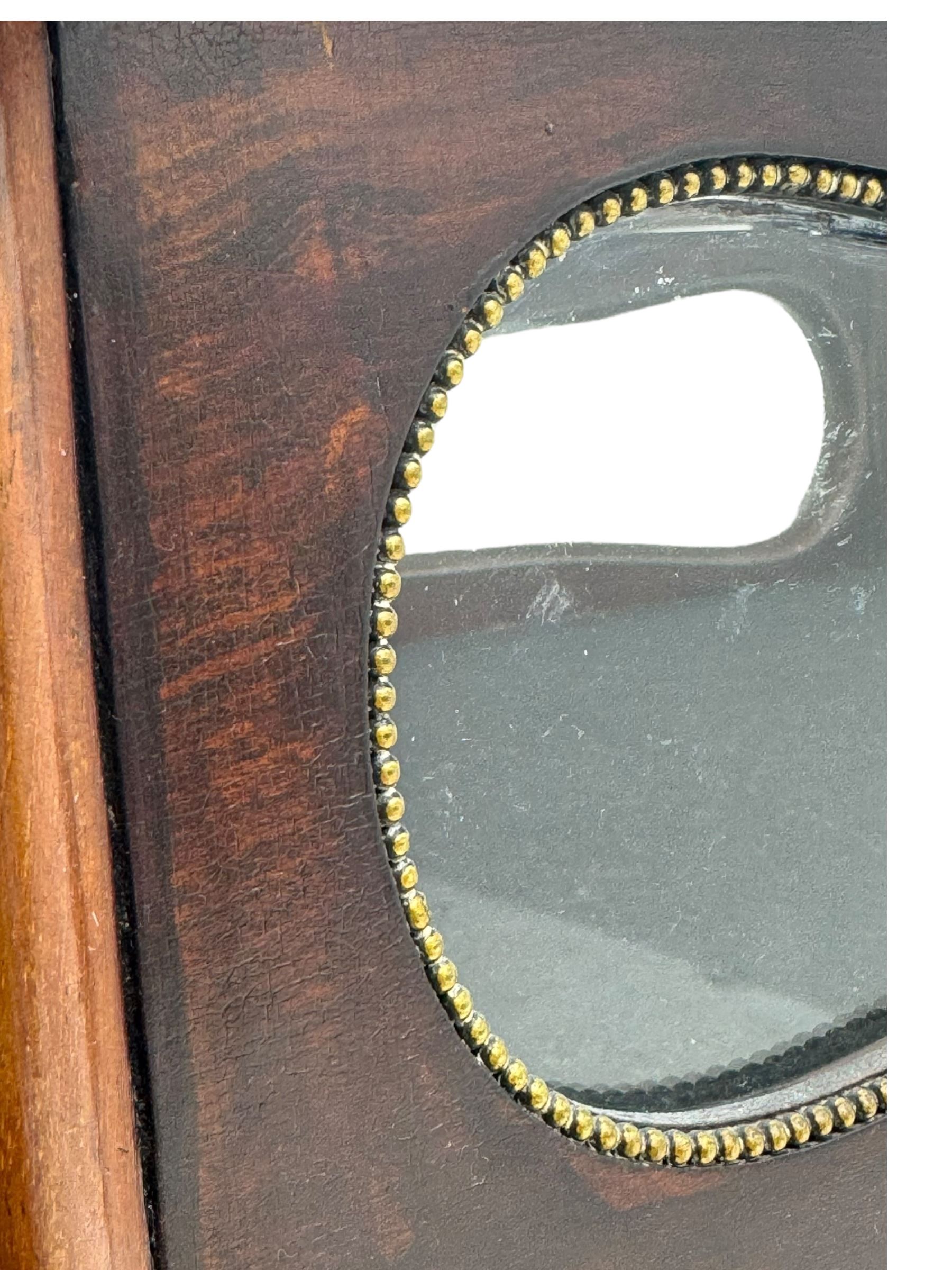 Late 19th century inlaid mahogany bijouterie table, glazed hinged top with floral marquetry, enclosing a felt-lined interior, lower shelf, ormolu mounts on cabriole supports with gilt accents