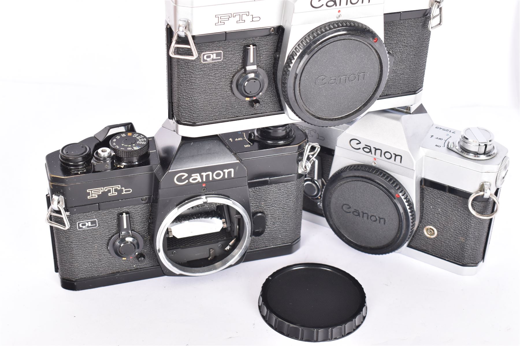 Three Canon FTb SLR camera bodies, to include a black example, serial no. 869426, and two black and silver examples, serial no. 712549 and 192507