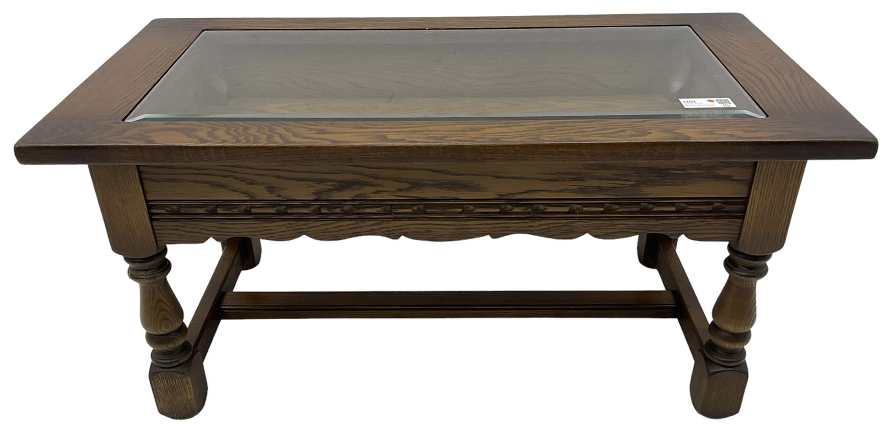 Old Charm - oak coffee table, rectangular top with glass inset over carved scalloped apron, on turned square supports connected by H-stretcher