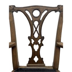 Unusual 18th century mahogany elbow chair, the shaped cresting rail with projecting shell carved ears, pierced and scroll carved splat over drop-in upholstered seat, shaped arms with ball and claw carved terminals, the seat rails carved with shell cartouches, on foliate carved cabriole supports with ball and claw feet 