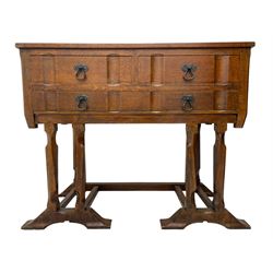 Arts & Crafts design oak chest on stand, rectangular top over two short and one long drawer, on a series of shaped and tapered supports with carved and beaded decoration, united by chamfered stretchers rails, on sledge feet 