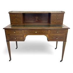 Edwardian inlaid mahogany writing desk, raised galleried back over inlaid central urn with scrolling leafy branches and six small drawers, satinwood banded rectangular moulded top with tooled leather inset, fitted with five drawers, the drawer facias inlaid with scrolling foliage and satinwood banding, square tapering supports inlaid with trailing bell flowers, on brass and ceramic castors 