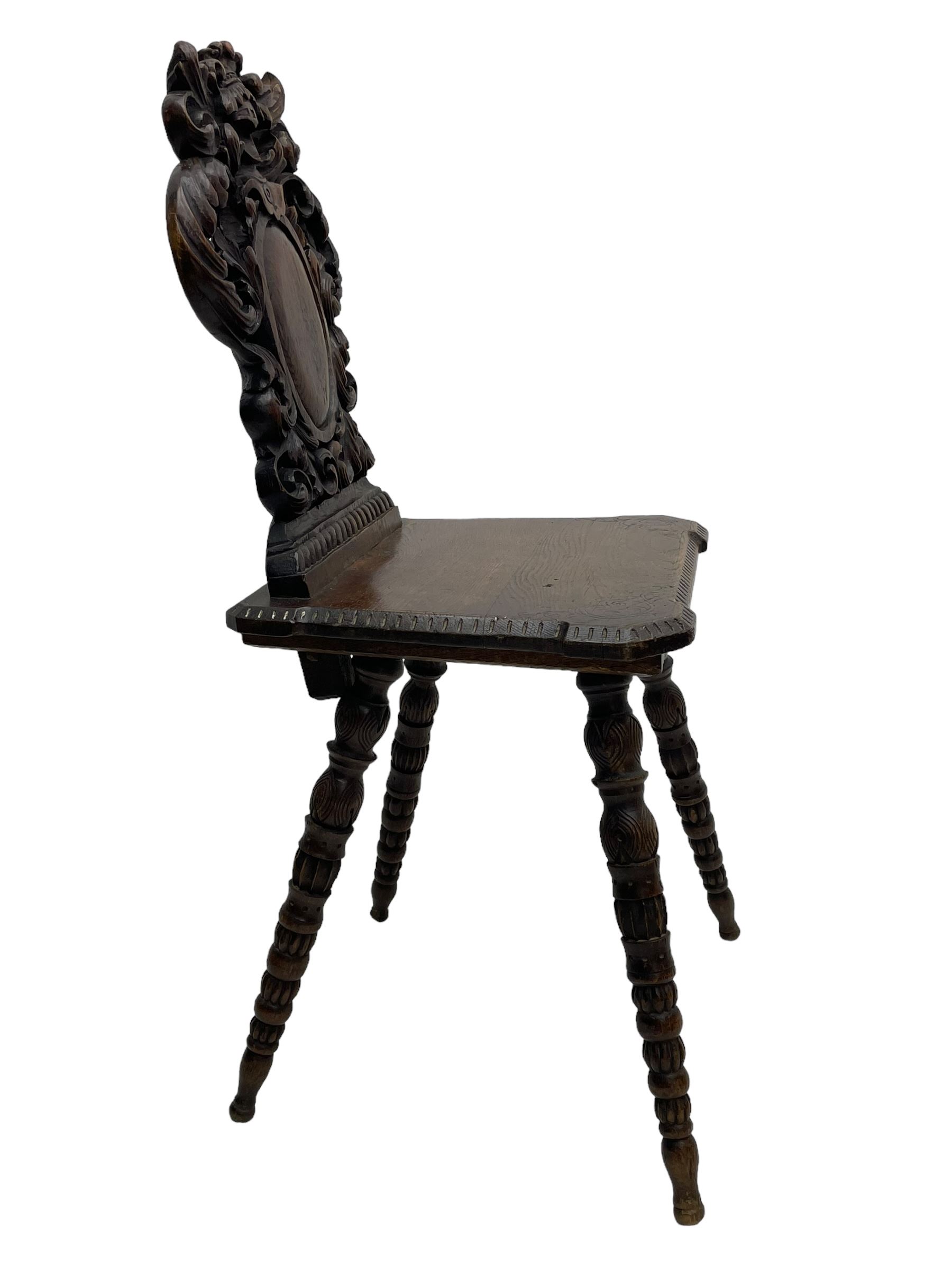 19th century oak hall chair, shaped and pierced back carved with crown cresting over curled and scrolled acanthus leaves, tapered rectangular seat with foliate carved corners and fluted chamfered edge, on turned and lobe carved splayed supports 