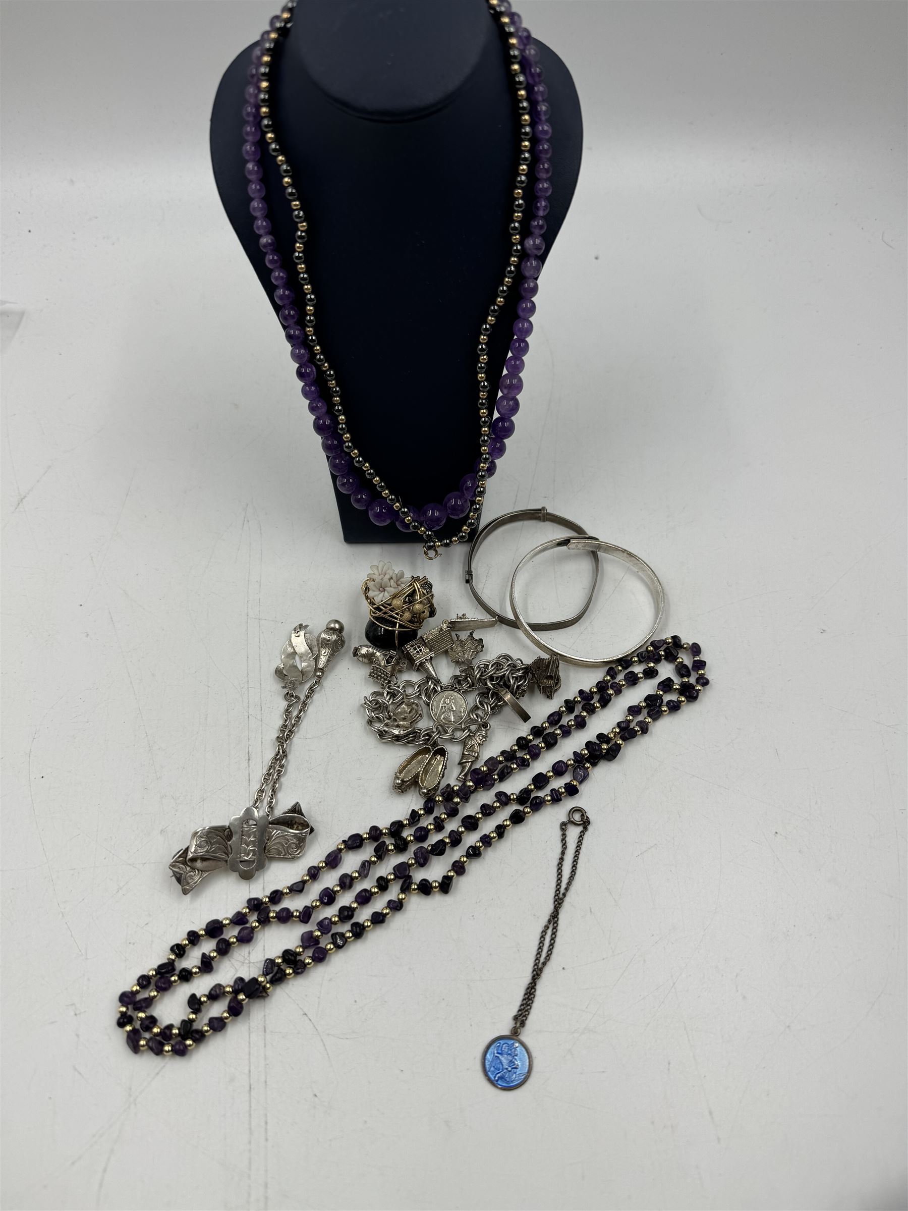 Amethyst bead necklace, with 9ct gold barrel clasp, together with a heamatite necklace with 9ct gold clasp, one other beaded necklace, silver charm bracelet, two silver bangles, silver buckle brooch and a 14ct gold filled wirework ring