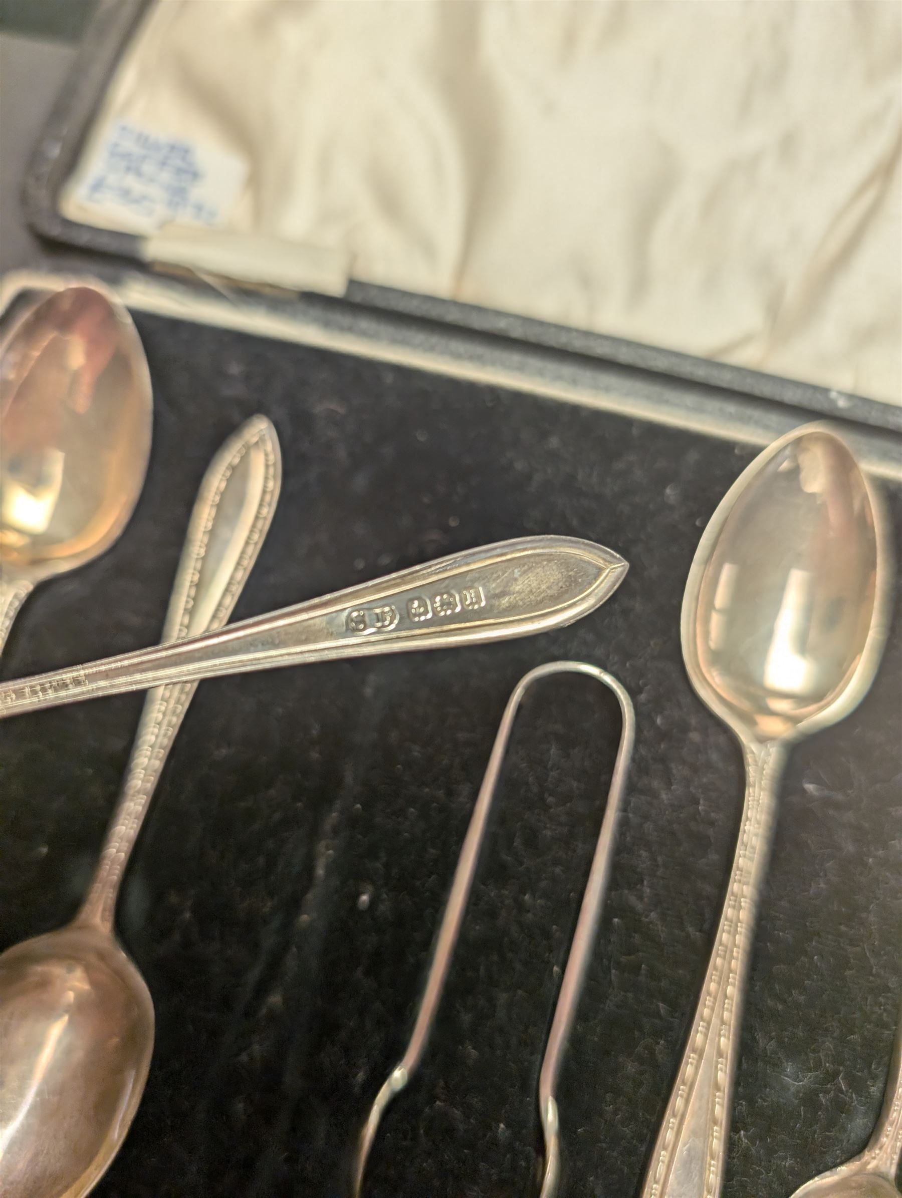 Cased set of six silver coffee spoons and a pair of sugar tongs, hallmarked 