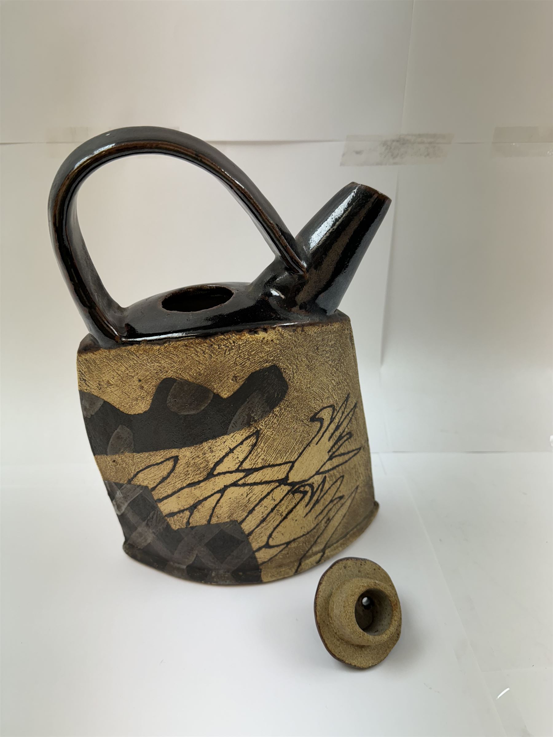 John Maltby (British 1936-2020): studio pottery teapot decorated with flowers, the spout and handle with tenmoku glaze, signed beneath, including handle H29cm