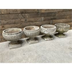 Pair of circular cast stone circular planters, and a similar pair decorated with swags (4)