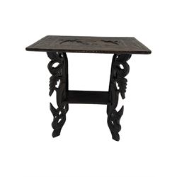 Early 20th century Anglo-Indian heavily carved hardwood table, the rectangular top carved with lion amongst trees, scrolling branch and foliage border, on leaf carved and pierced supports united by undertier 