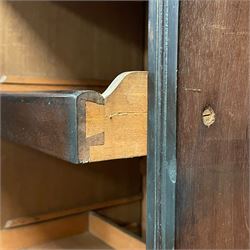 19th century Irish mahogany press wardrobe, projecting dentil cornice over two figured panelled doors, enclosing three sliding trays and hanging rail with coat hooks, fitted with two drawers to base over a shaped apron, raised on acanthus carved cabriole supports with paw feet, retailed by Millar & Beatty of Dublin, with paper labels verso, collected and restored by Michael Butler (1870-1900), impressed stamp to side and ink stamp to drawer inscribed 'M Butler collector of high-class furniture and works of art'