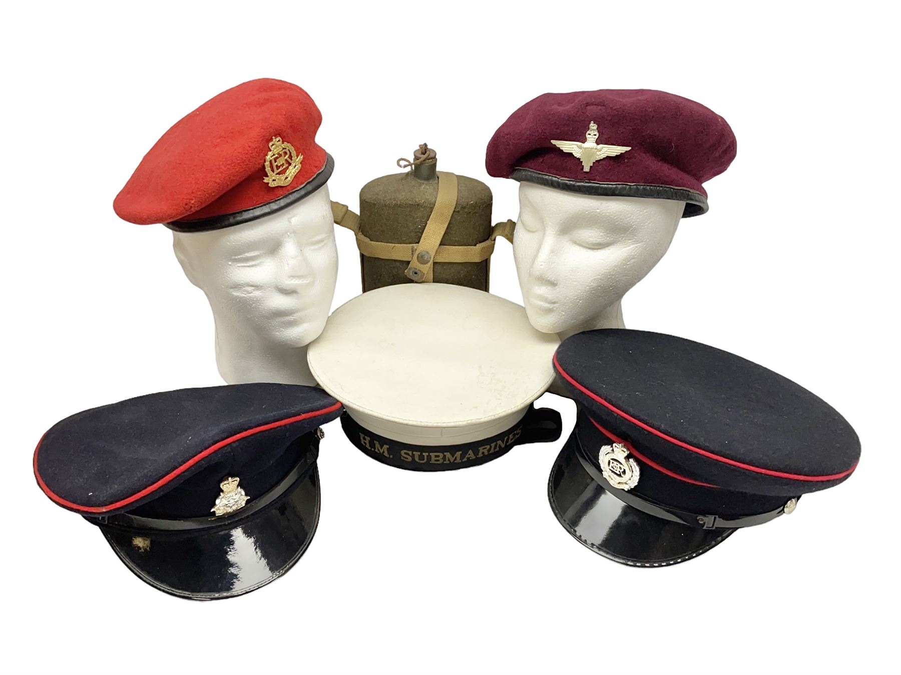 Five military caps/berets comprising two peaked caps with 'Yorkshire' and 'Royal Engineers' badges; maroon beret with parachute regiment badge; red beret with Military Police badge; and AB seaman hat with HM Submarines band; and a felt and webbing covered water bottle (6)