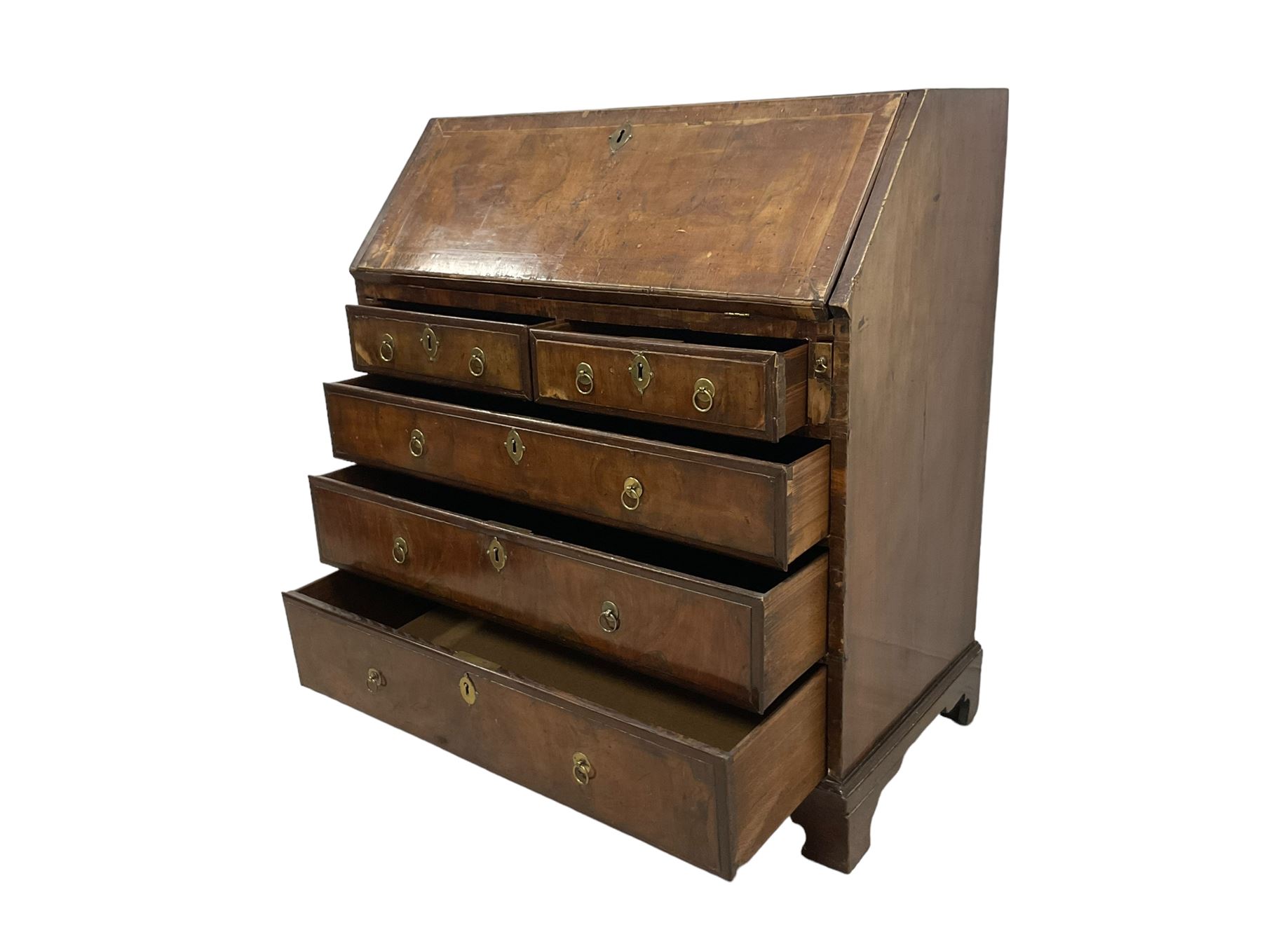 18th century walnut bureau, crossbanded and feather-banded rectangular top and fall-front, enclosing fitted interior with pigeonholes and correspondence drawers with bone handles, over two short and three long graduating drawers with moulded facias and original brass handles, on bracket feet