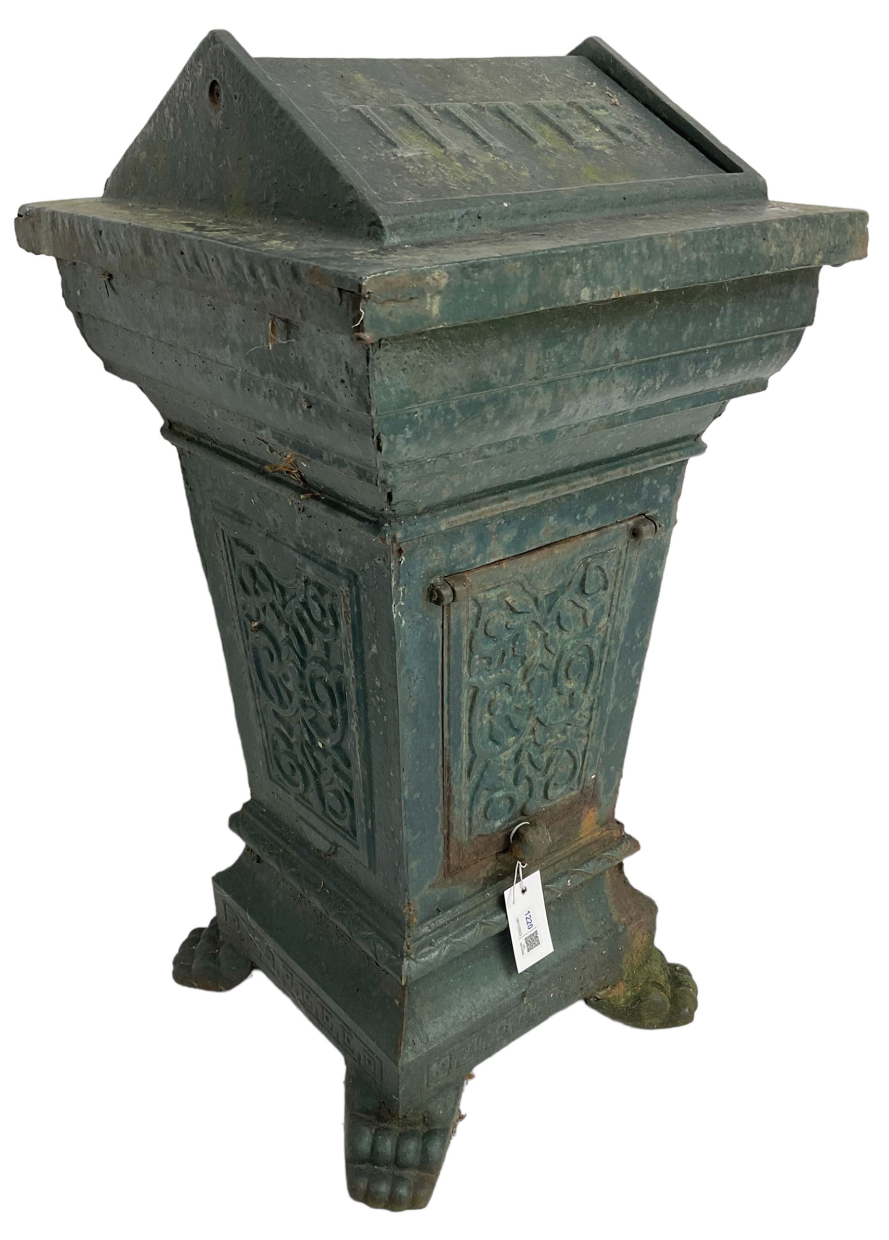 Early 20th century cast iron litter bin, square tapering form with scrolling foliate decoration, on paw feet