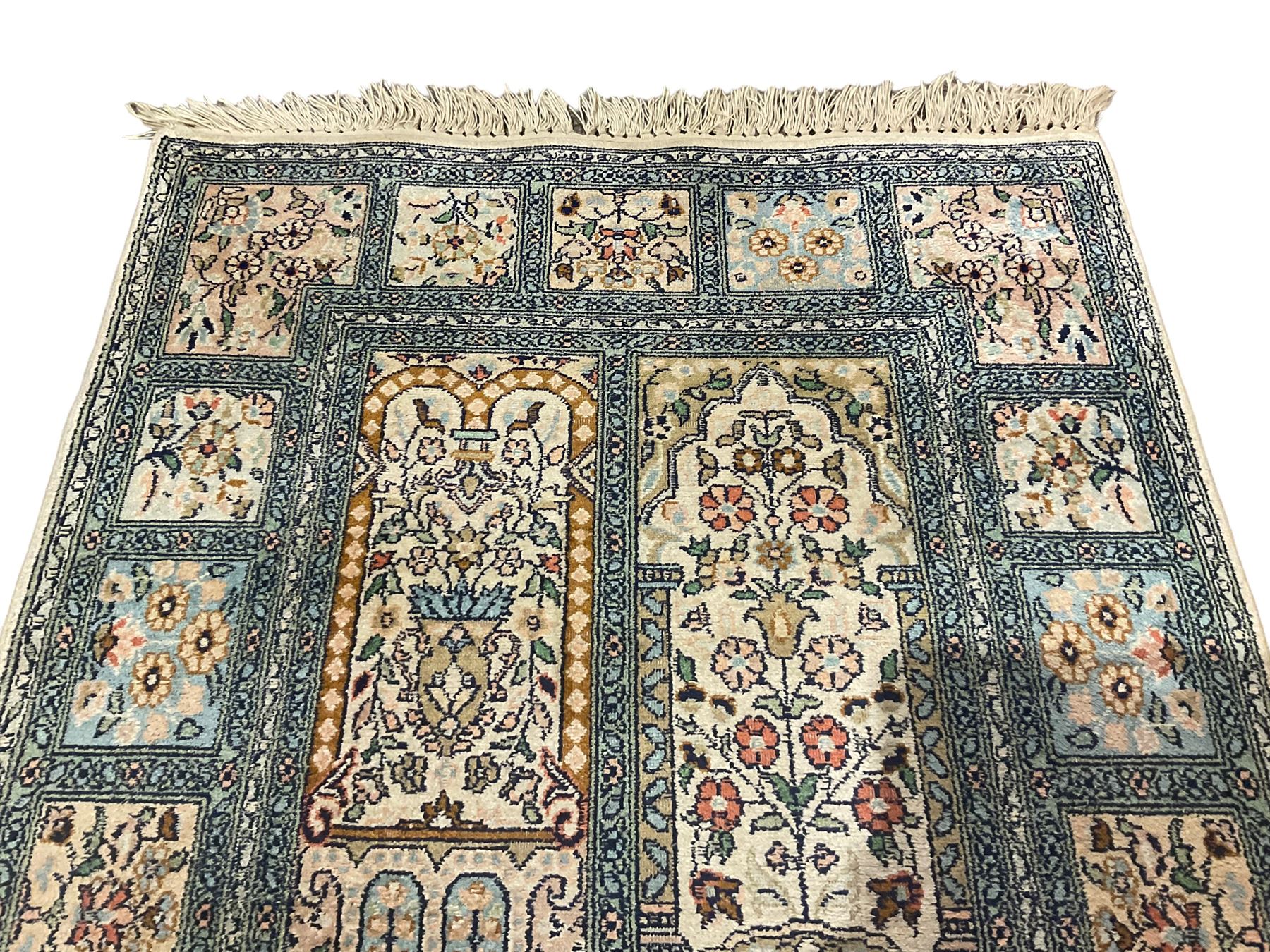 Fine Persian Kashmir ivory and pale indigo ground runner rug, the field decorated with sixteen rectangular panels depicting Mirab motifs and other traditional carpet designs, the border with repeating square panels of floral bouquets and foliate patterns