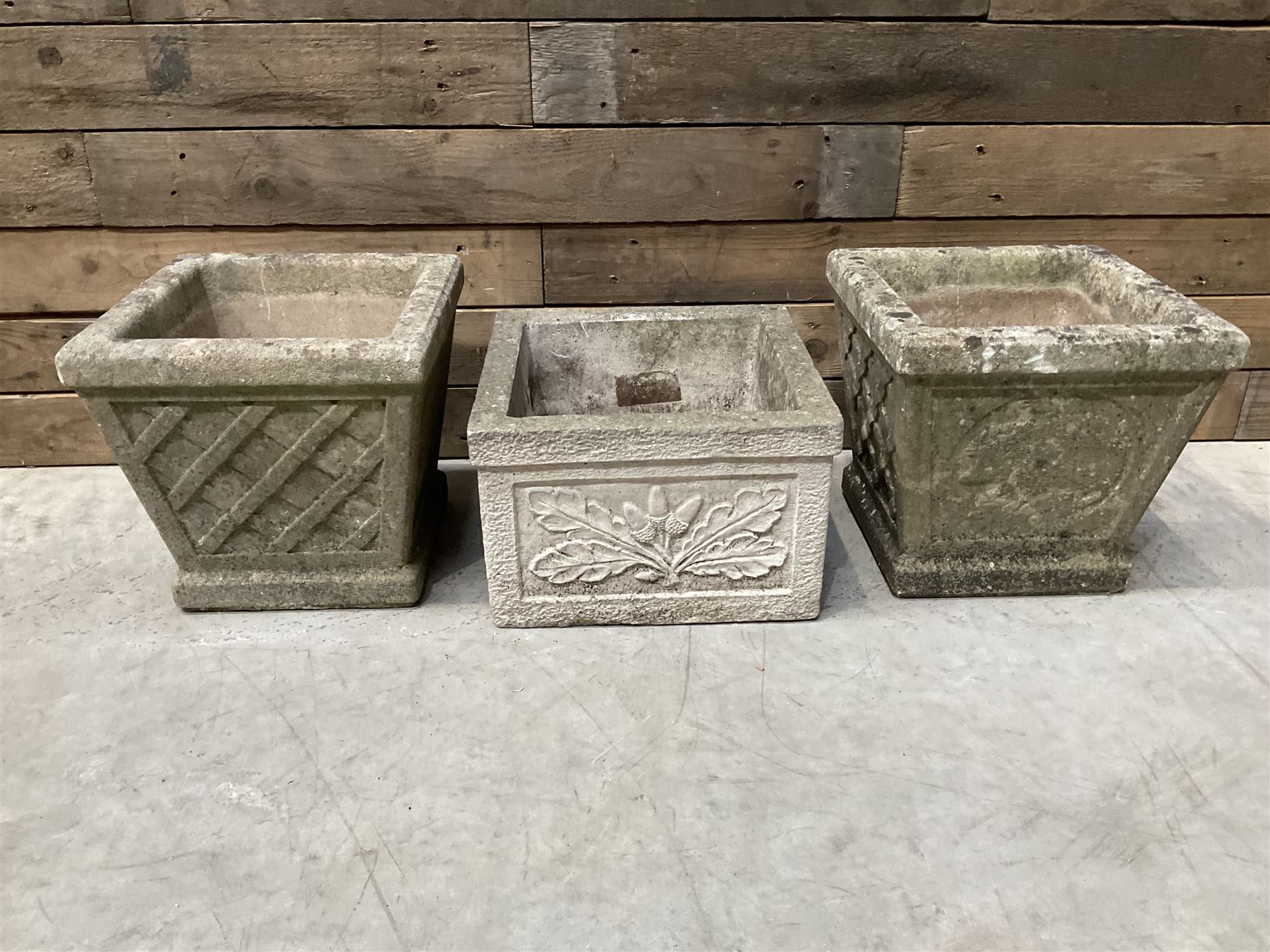 Pair of square cast stone planters, single planter with leaf decoration and a rectangular brick effect planter (4)