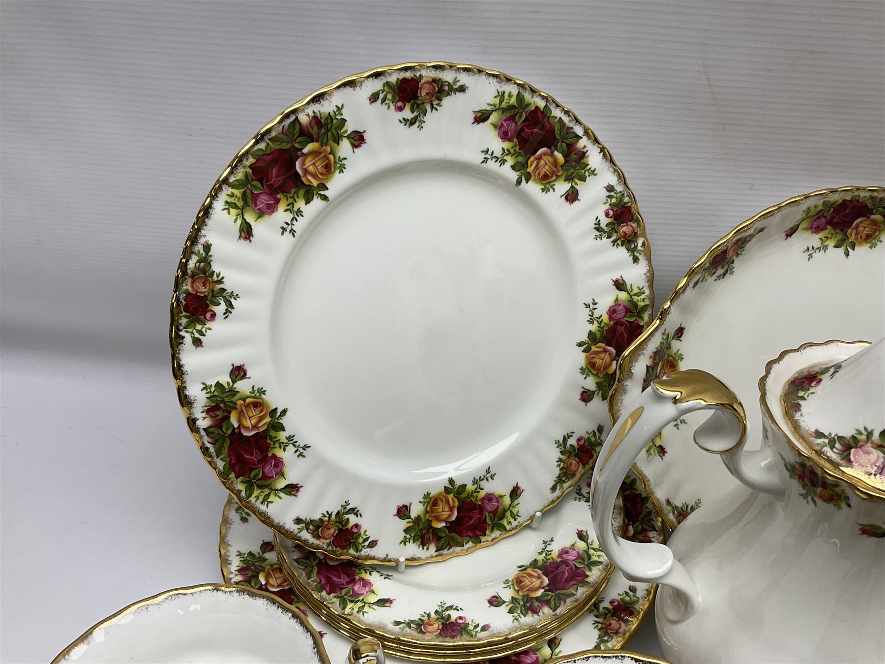 Royal Albert Old Country Roses pattern coffee service for six, comprising coffee pot, milk jug, cups and saucers, cake plate, together with miniature teapot, six teacups and saucers, six dinner plates, six side plates etc 