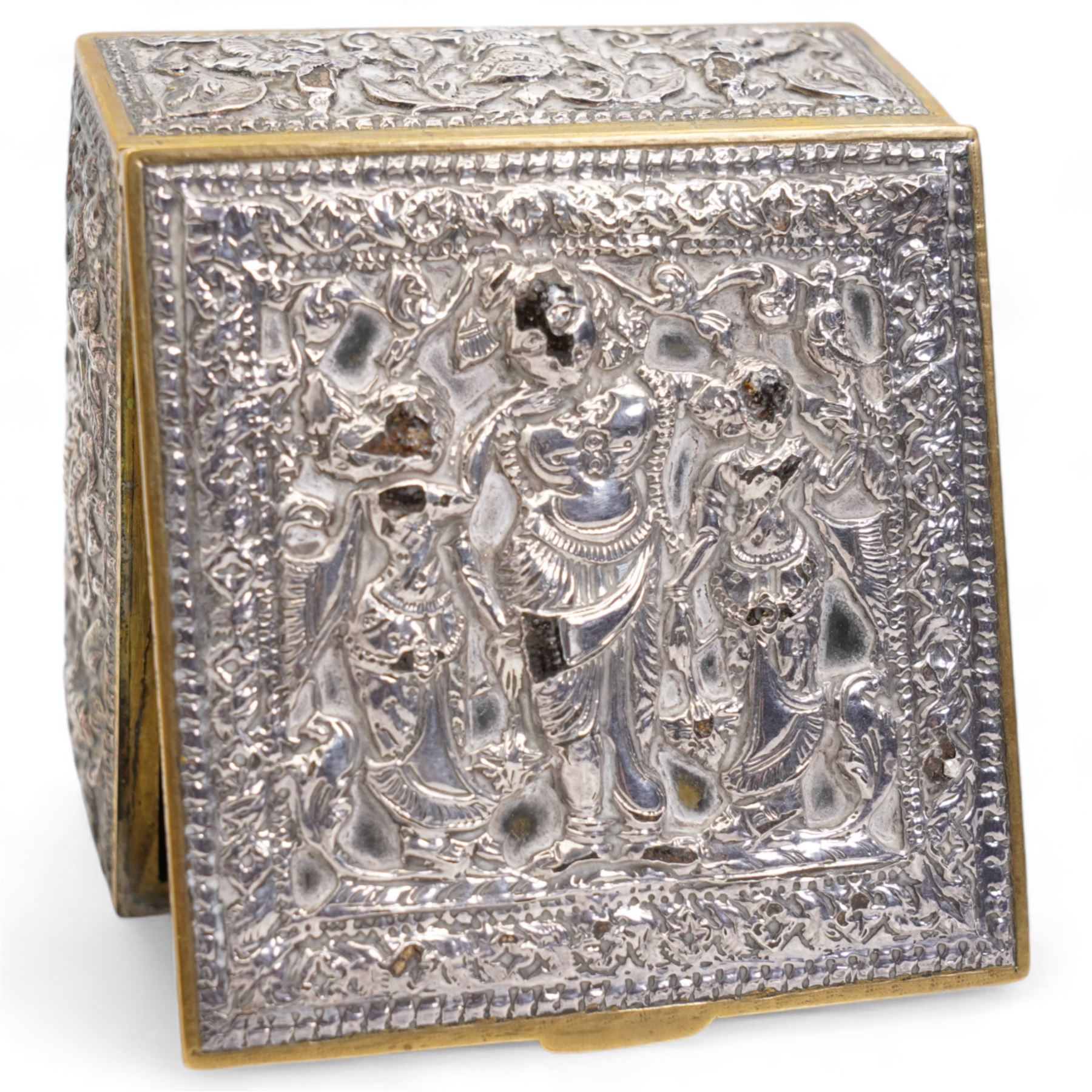 Pair of silver cylindrical dressing table boxes and covers embossed with trailing foliage H7cm, silver upright table photograph frame Birmingham 1909, Indian white metal and glass paperweight and a silver on copper trinket box