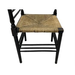 In the manner of William Morris - Arts & Crafts period corner chair, swell turned horizontal rails with balustrade back, rush seat on ring turned supports, black paint finish 