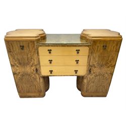 Early 20th century Art Deco twin pedestal sideboard, the pedestals fitted with single drawer over single cupboard enclosing shelf, flanking three central drawers with a figured band 