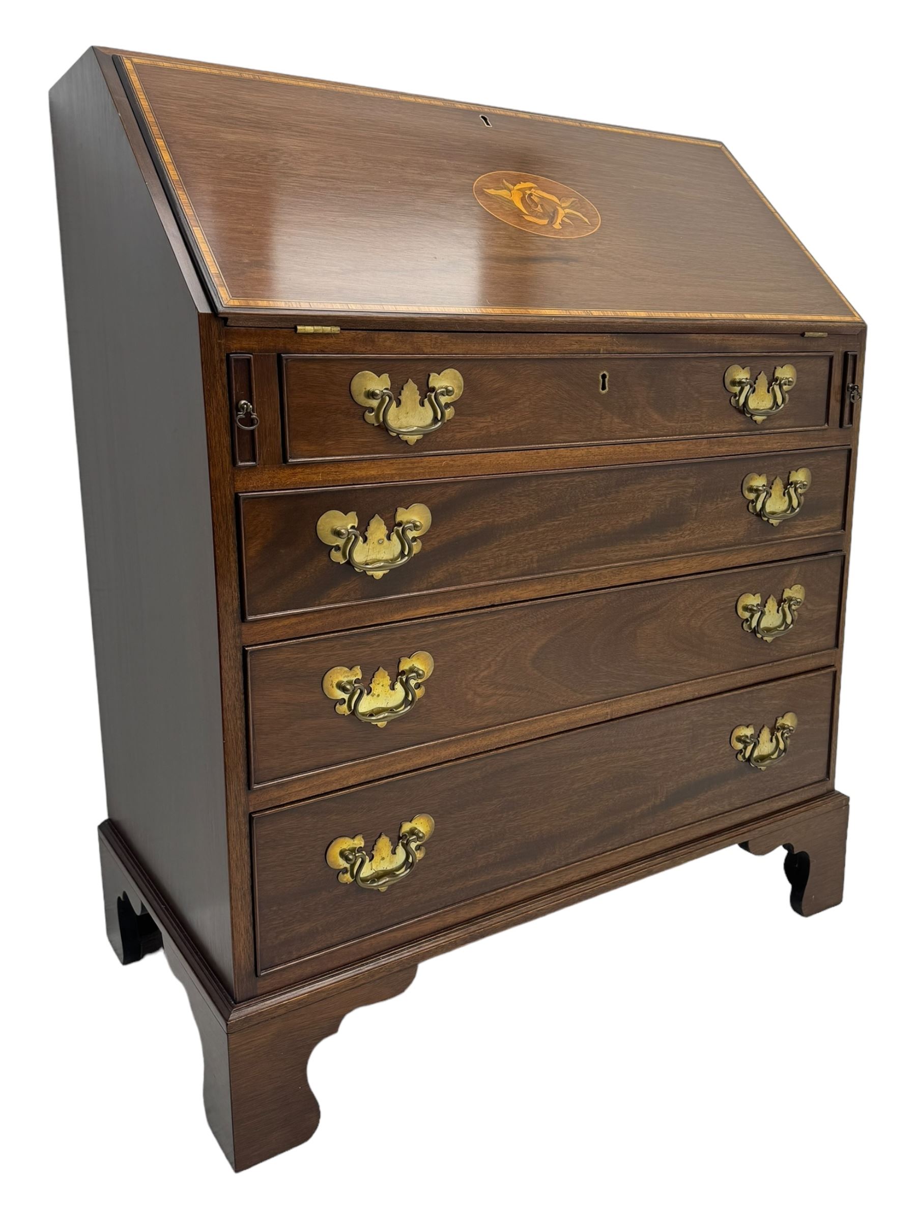 Mid-to-late 20th century inlaid mahogany bureau, inlaid floral medallion to the top, the fall front opening to reveal fitted interior with pigeonholes, small drawers and central cupboard, green inset writing surface with gilt tooling, four drawers below with brass handles, raised on shaped bracket feet