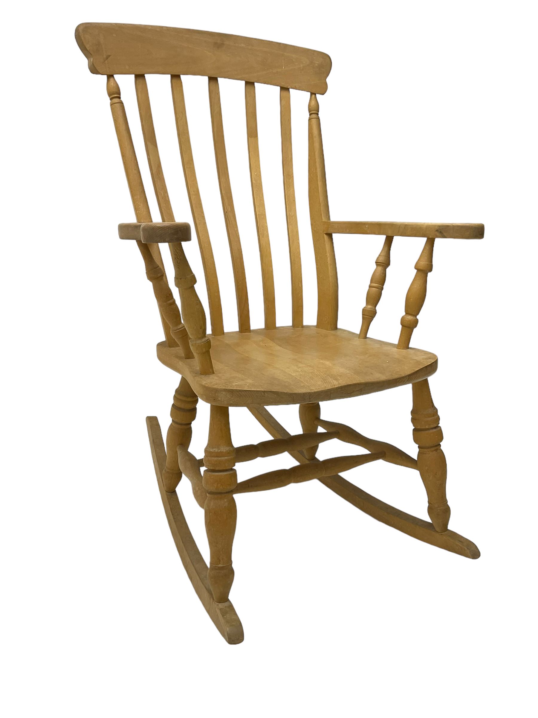 Farmhouse style beech rocking chair, shaped cresting rail on vertical slats, on turned front supports joined by swell-turned double H stretcher base