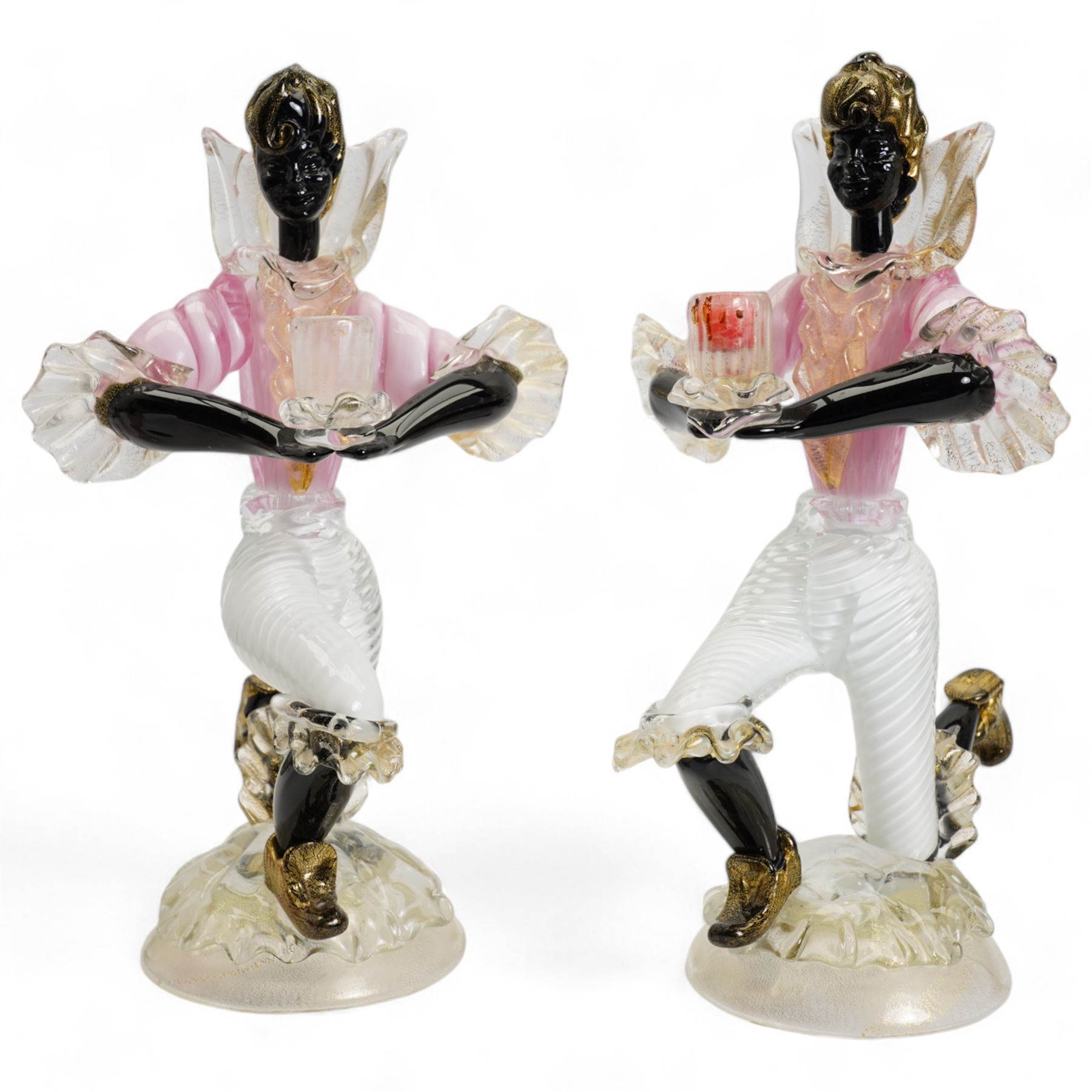 Pair of Murano figural glass Blackamoor candlesticks, each kneeling supporting the single sconce, on domed circular bases with aventurine inclusions, H31cm, together with a matching bowl, L22.5cm (3)