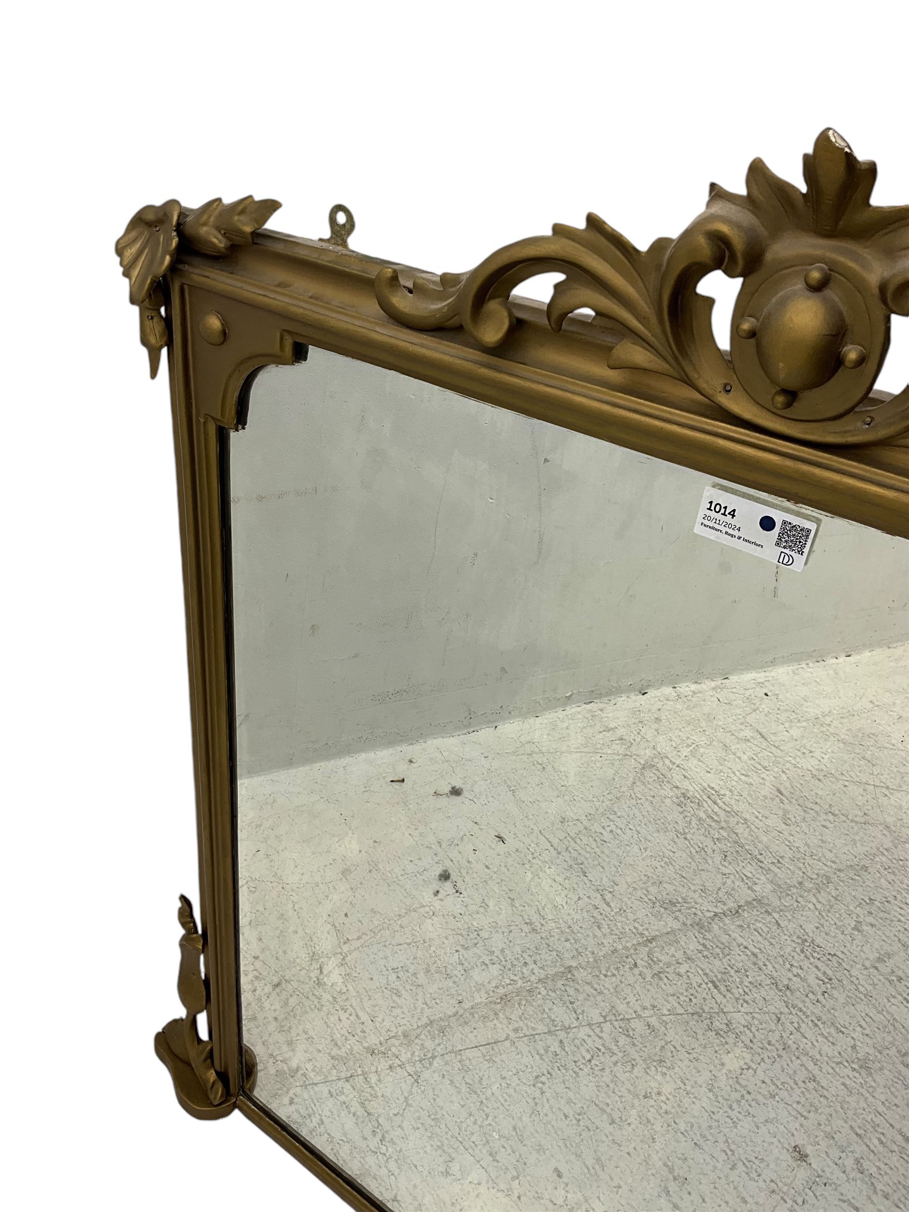 19th century gilt framed overmantel mirror, cartouche pediment surrounded by curling leaves, moulded framed enclosing plain mirror plate, decorated with applied trailing foliage motifs 