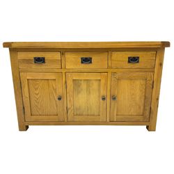 Contemporary light oak sideboard, fitted with three drawers over three panelled cupboards enclosing shelving, on square supports