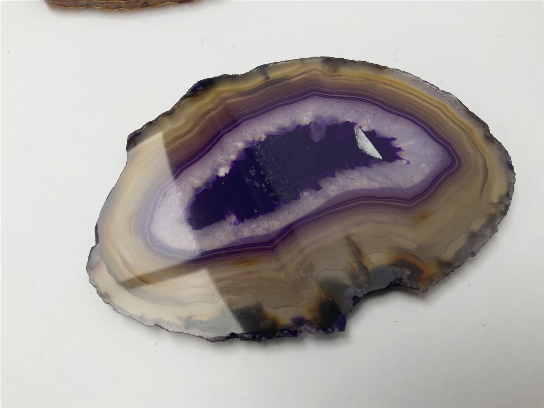 Three purple agate slices, polished with rough edges, of various sizes largest H7cm, L10cm