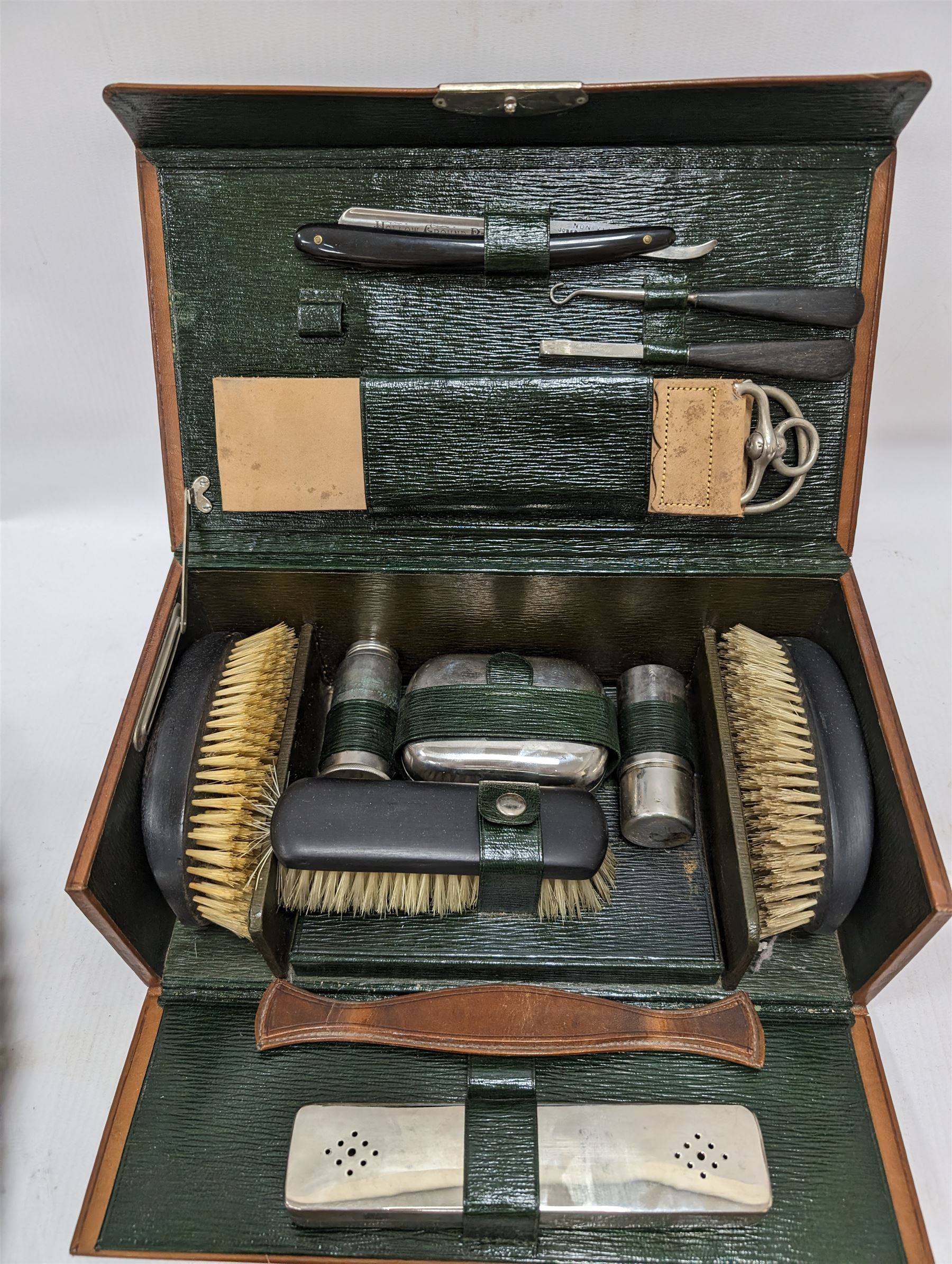 Gentleman's vanity set, containing ebony brushes, chrome jars and bottles, within fitted leather carrycase, together with two other similar brushes 