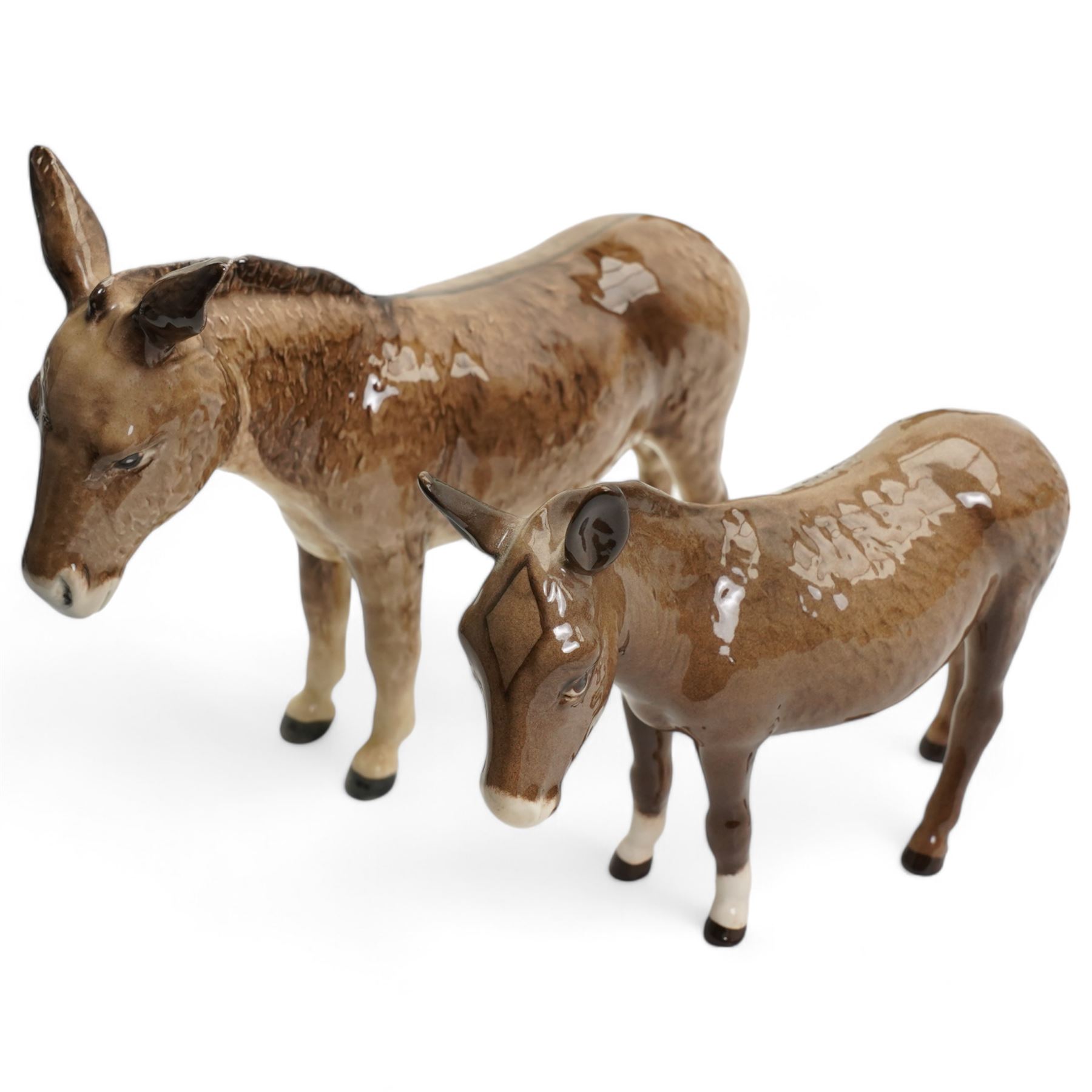 Group of Beswick horses and donkeys, including Connemara pony, a grey gloss stallion and foal, Black Beauty, another foal, two shire horses and two donkeys 