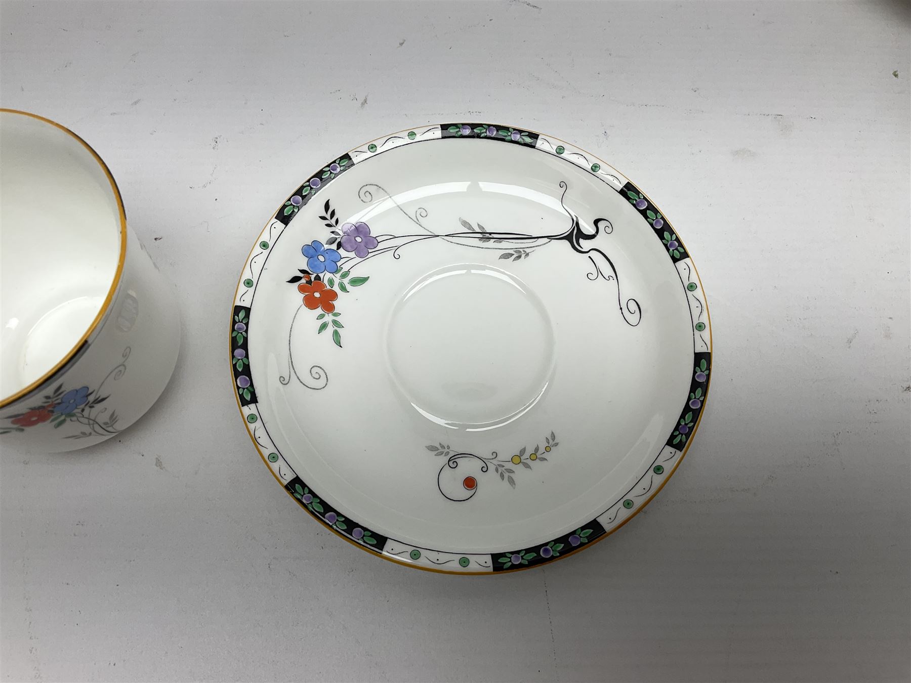 Art deco Shelley tea service for eight, decorated with floral sprigs, comprising teacup and saucers, dessert plates, two cake plates, milk jug and open sucrier, with to extra dessert plates