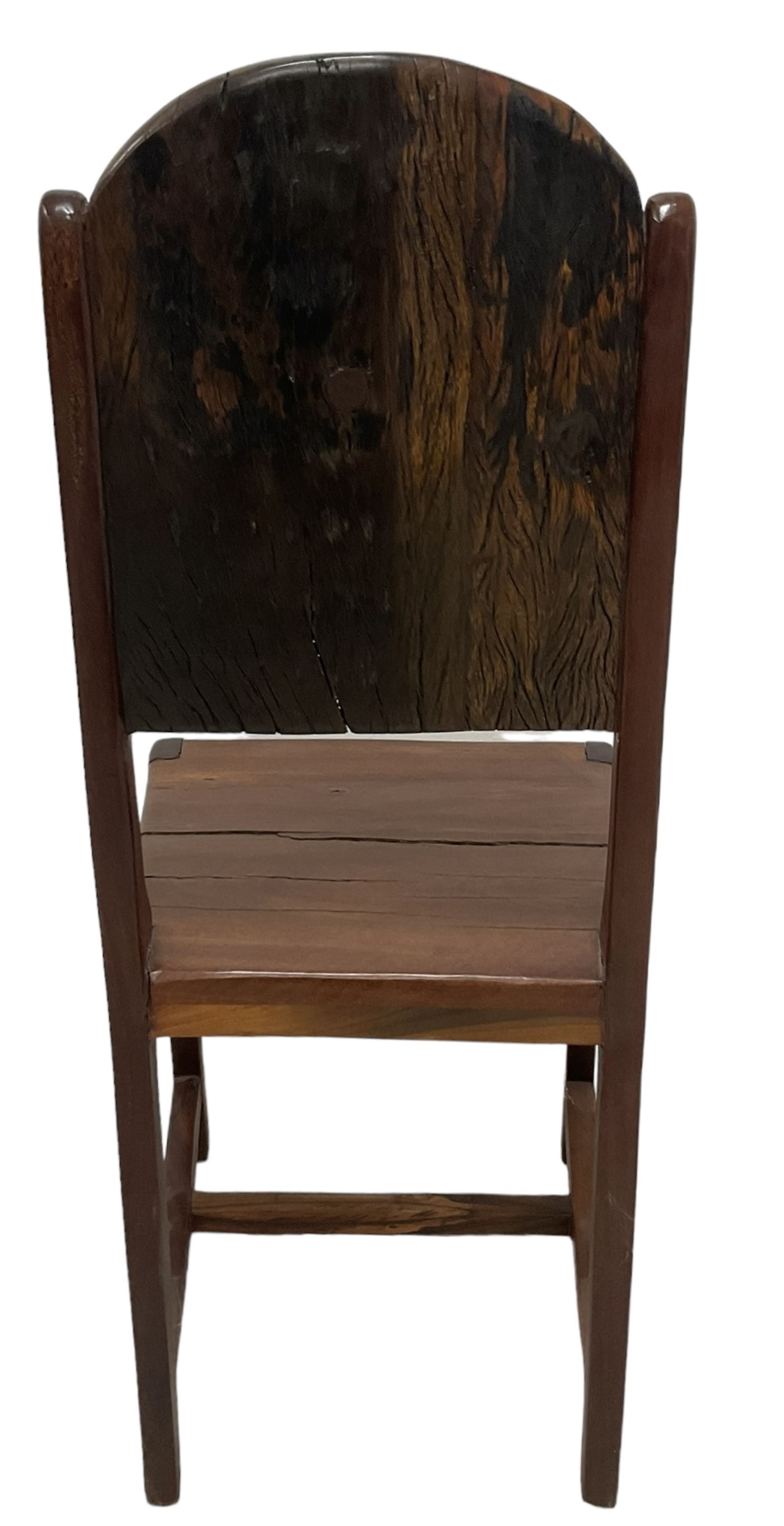 Mid-to-late 20th century teak dining table, rectangular top with canted corners, on square tapering supports with spade feet (214cm x 119cm, H76cm); and a set of eight Burmese reclaimed teak dining chairs, high arched back over panelled seat