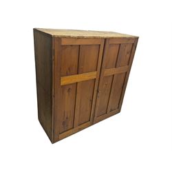 Large 19th century pine cupboard, rectangular top over two panelled later doors, enclosing four open shelves, on plinth base