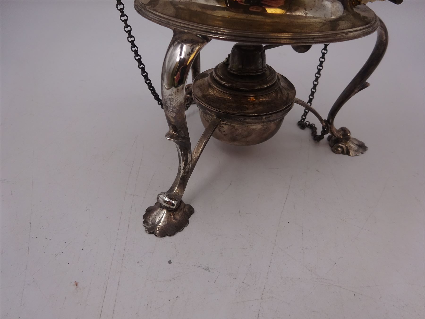 Early 20th century silver spirit kettle and burner, of oval form, with oblique gadrooned rim, engraved crest and ebonised handle and finial, the stand upon three scrolling pad feet, hallmarked Goldsmiths Silversmiths Company, London 1913, total H31cm