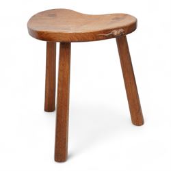 Mouseman - oak kidney-shaped stool, on three tapered octagonal supports, carved with moues...