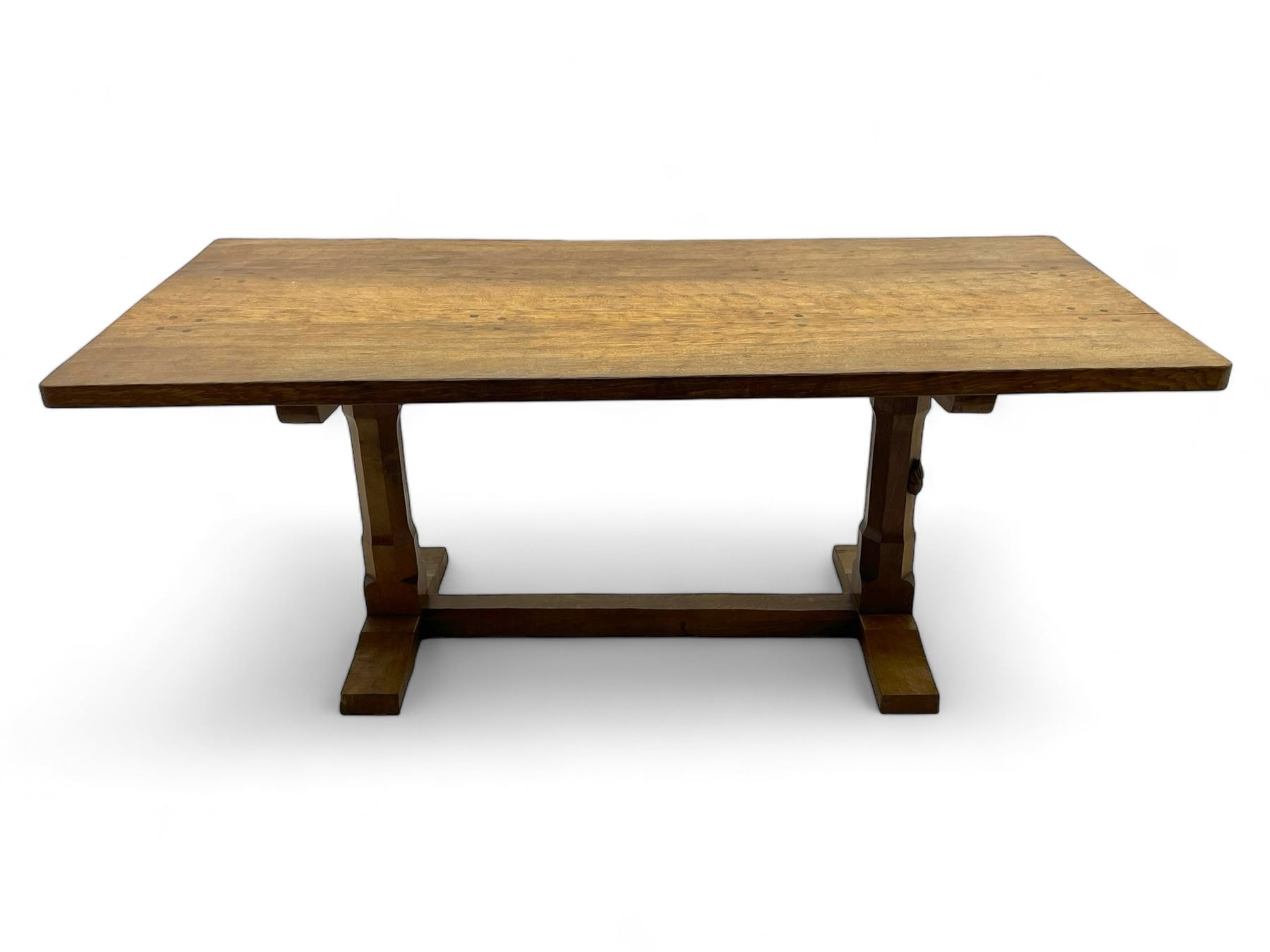 Rabbitman - oak dining table, rectangular adzed top, twin octagonal pillar supports on sledge feet, united by floor stretcher, carved with rabbit signature, by Peter Heap of Wetwang 