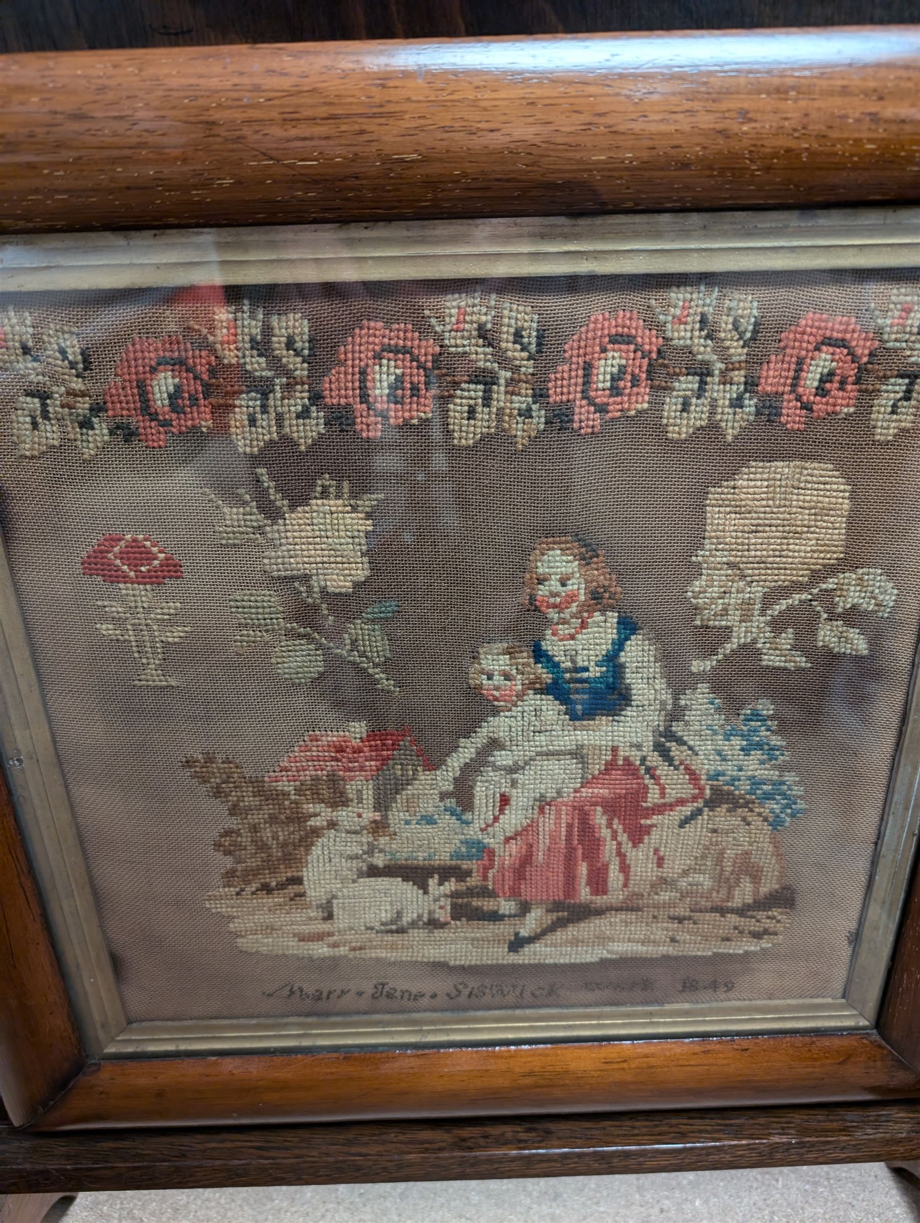 Victorian sampler, depicting woman and young child feeding rabbits, worked by Mary Ann Siswick 1849, set within an oak fire screen, fire screen H75.5cm