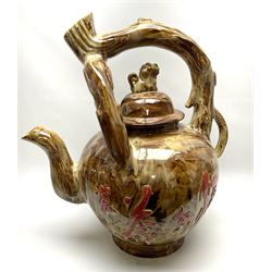A large novelty Chinese ceramic teapot, the body decorated with characters upon a mottled brown ground, with naturalistically modelled handle and domed cover with temple lion type finial, H62cm. 