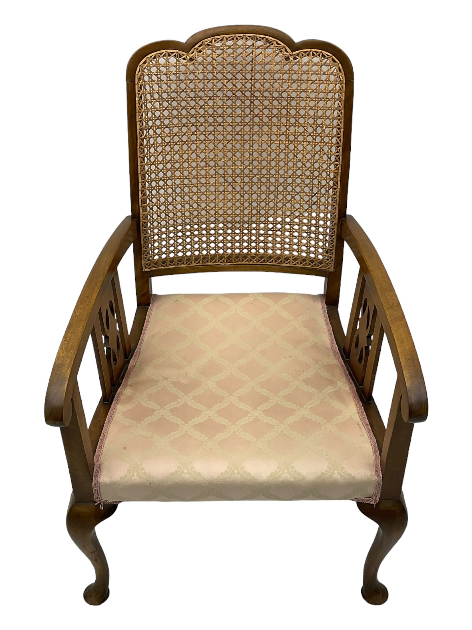 Early 20th century beech framed chair, with scalloped caned backrest, curved arms with pierced splats, upholstered seat in light pink fabric with gold trim, on cabriole supports