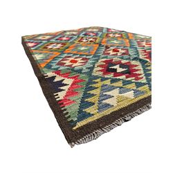 Maximana Kilim ground rug, the field decorated with a geometric pattern of multi-coloured diamonds and triangles, each containing stylised motifs, enclosed by a plain brown border