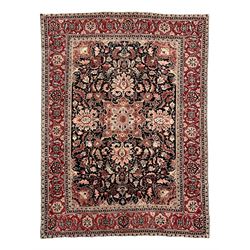 Persian Heriz dark indigo and red ground carpet, the central medallion with large projecti...