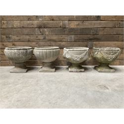 Pair of circular cast stone circular planters, and a similar pair decorated with swags (4)