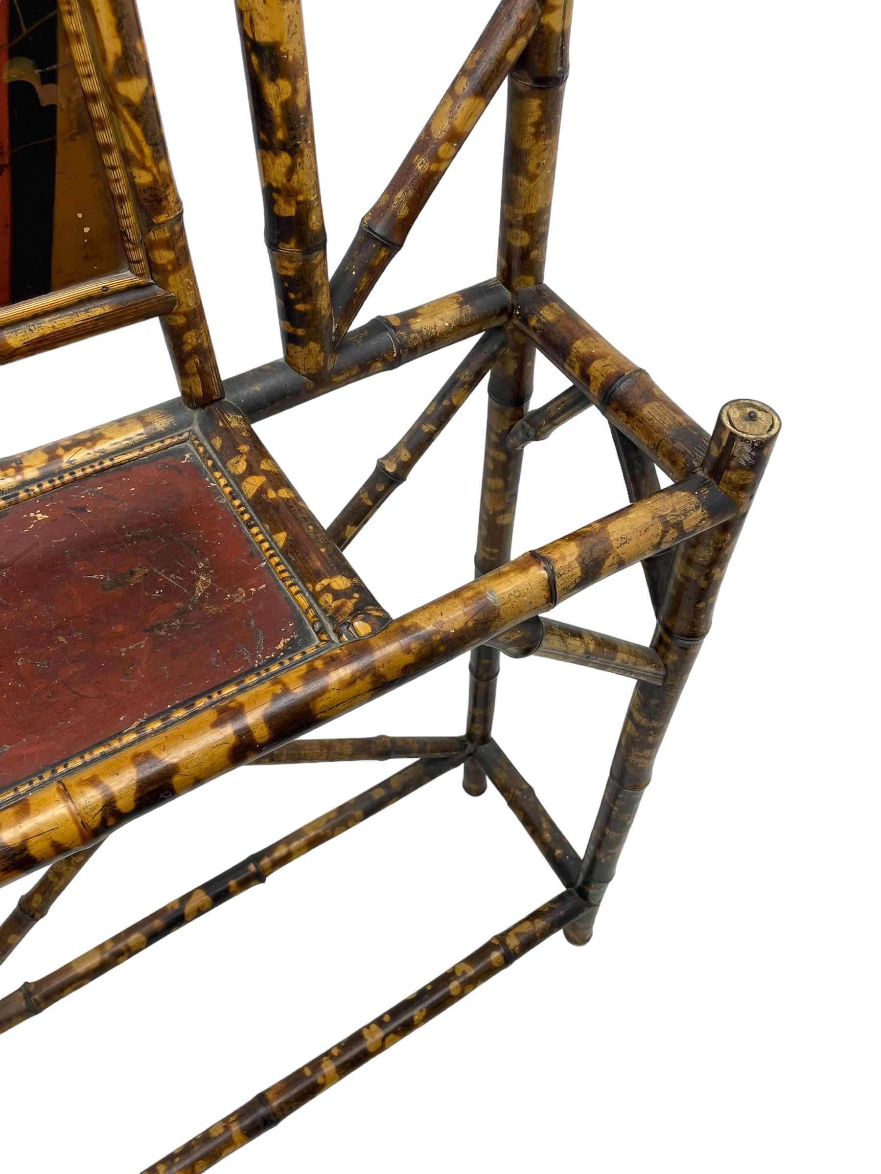 Victorian bamboo hallstand, bevelled mirror over red lacquered and chinoiserie decorated panels, fitted with six brass hooks 