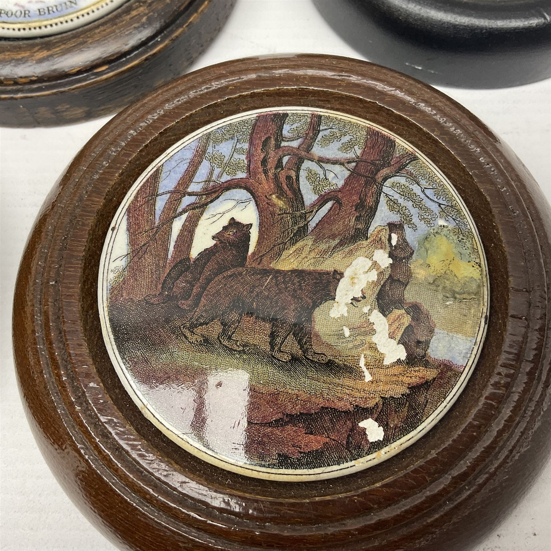 Six framed Prattware pot lids comprising 'Bear, Cock & Lion', 'Bear on Rock', 'Alas! Poor Bruin', ' Lady, Boy and Goats', 'The Shrimpers' and one other, largest D15.5cm (6)