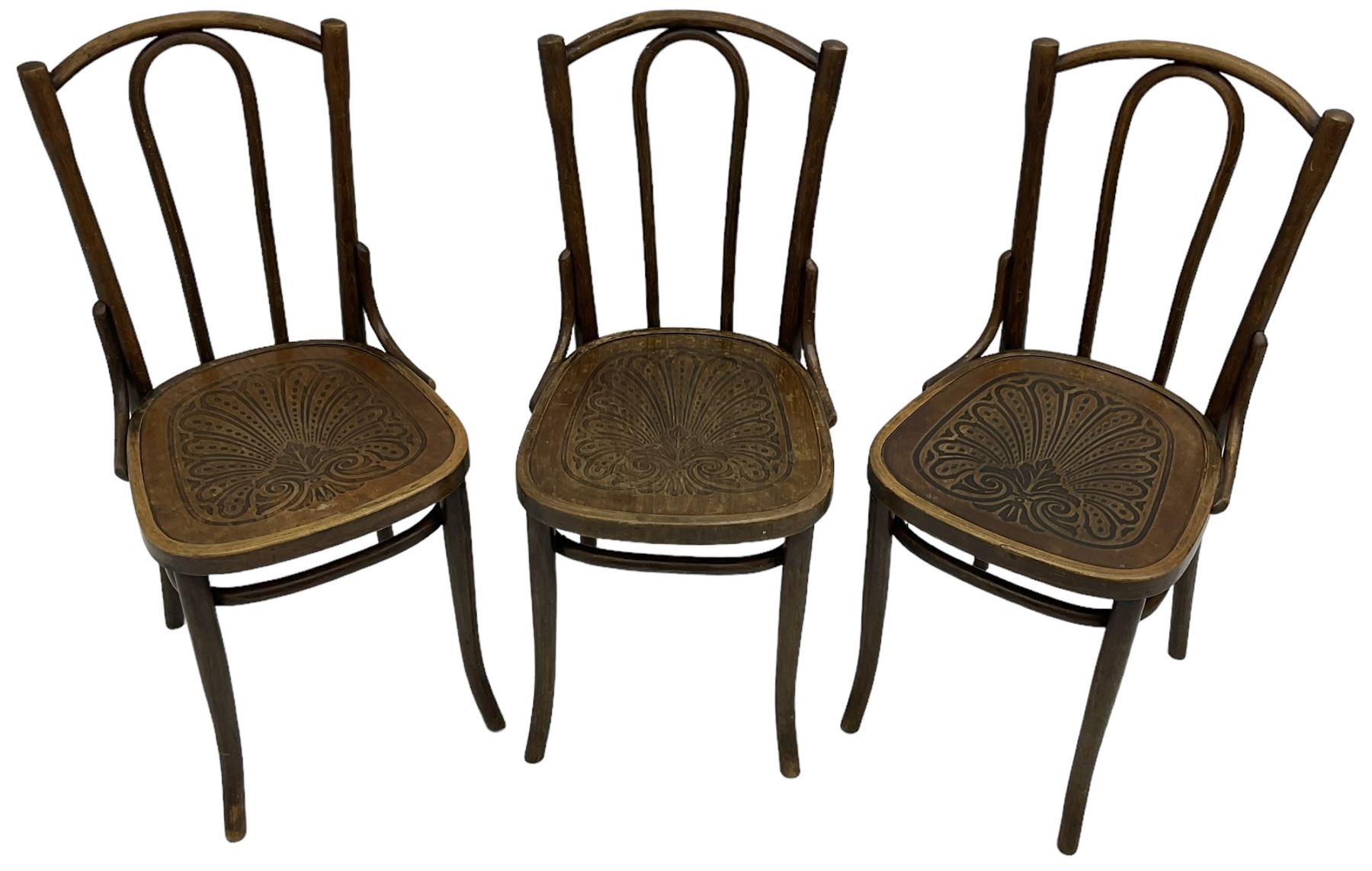 Set of three late 19th to early 20th century century bentwood dining chairs, the seats with pressed anthemion decoration, circa. 1900s