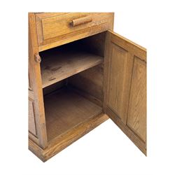 Arts & Crafts period oak bedside cupboard, raised back over moulded top, fitted with single drawer over panelled cupboard, panelled sides, on chamfered plinth base 